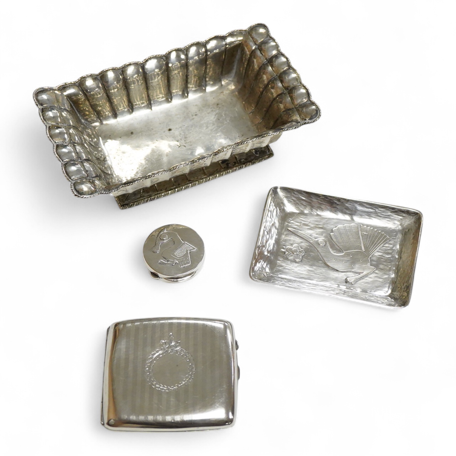 A continental 800 standard oblong shaped dish, of fluted design, together with a Peruvian sterling dish and similar pill box and a George V silver cigarette case, 16.6oz.